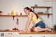 A woman sitting on top of a kitchen counter.