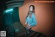 A woman in a blue sweater is standing on some stairs.