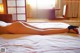 A naked woman laying on a bed in a hotel room.